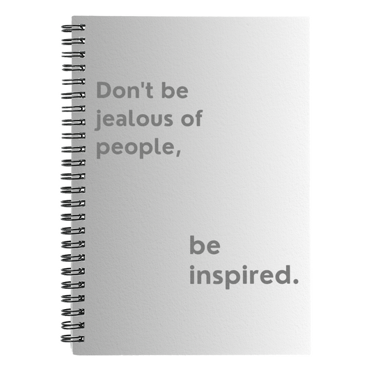 Motivational spiral notebook with quote “Don’t Be Jealous of People, Be Inspired” on printed cover.