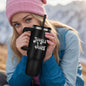 Woman holding Jingle Juice Christmas tumbler during holiday outing”