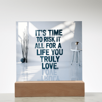 Motivational plaque placed beside framed photos and plants for cozy home inspiration.