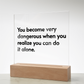 Close-up of engraved quote on transparent acrylic glowing with soft pink LED light