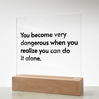 Close-up of engraved quote on transparent acrylic glowing with soft pink LED light