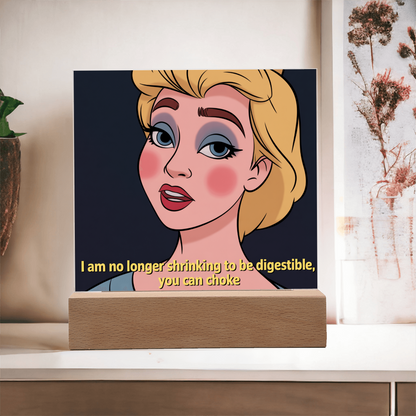 Softly lit photo of “No Longer Shrinking” acrylic sign creating empowering, reflective vibe in cozy corner