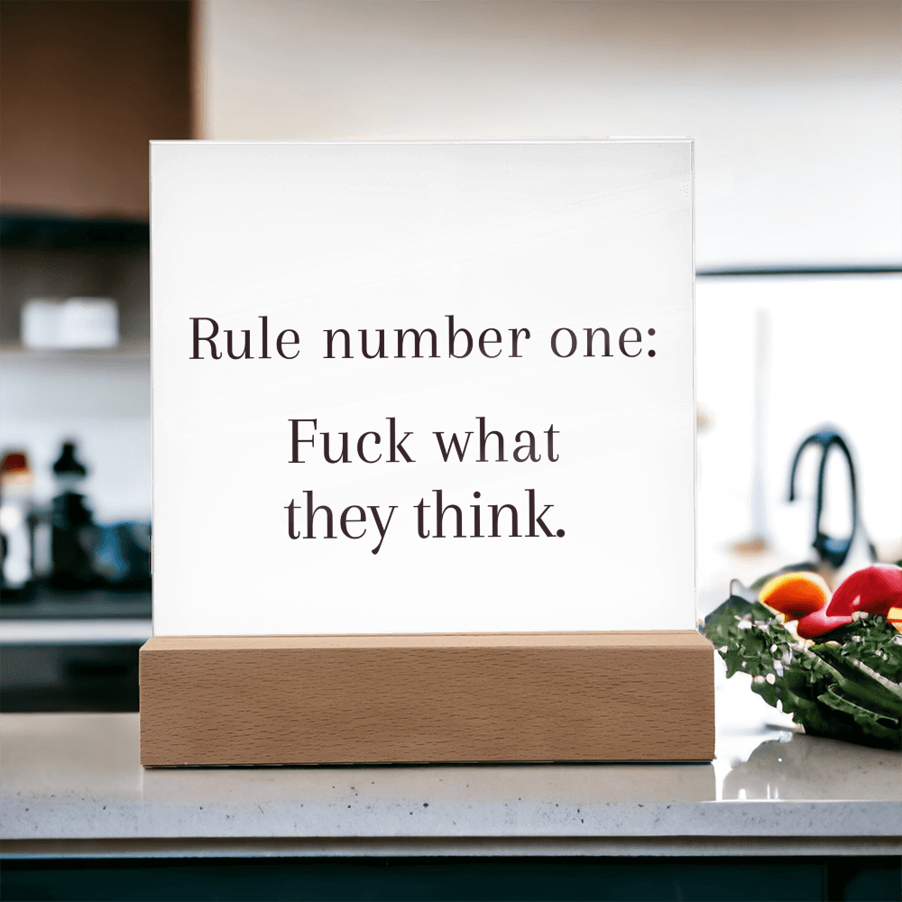 Empowering LED quote light on shelf surrounded by plants and books for modern inspirational home decor.