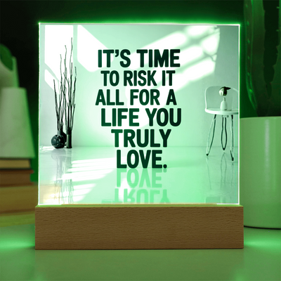 Motivational LED quote plaque beside laptop encouraging daily confidence.