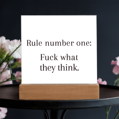 Acrylic plaque with quote photographed with notebooks, pens, and motivational card.