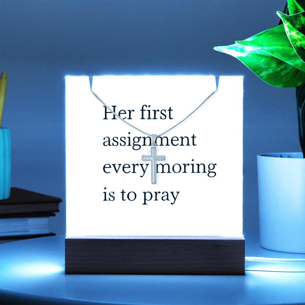 Cross pendant necklace displayed beside inspirational message card