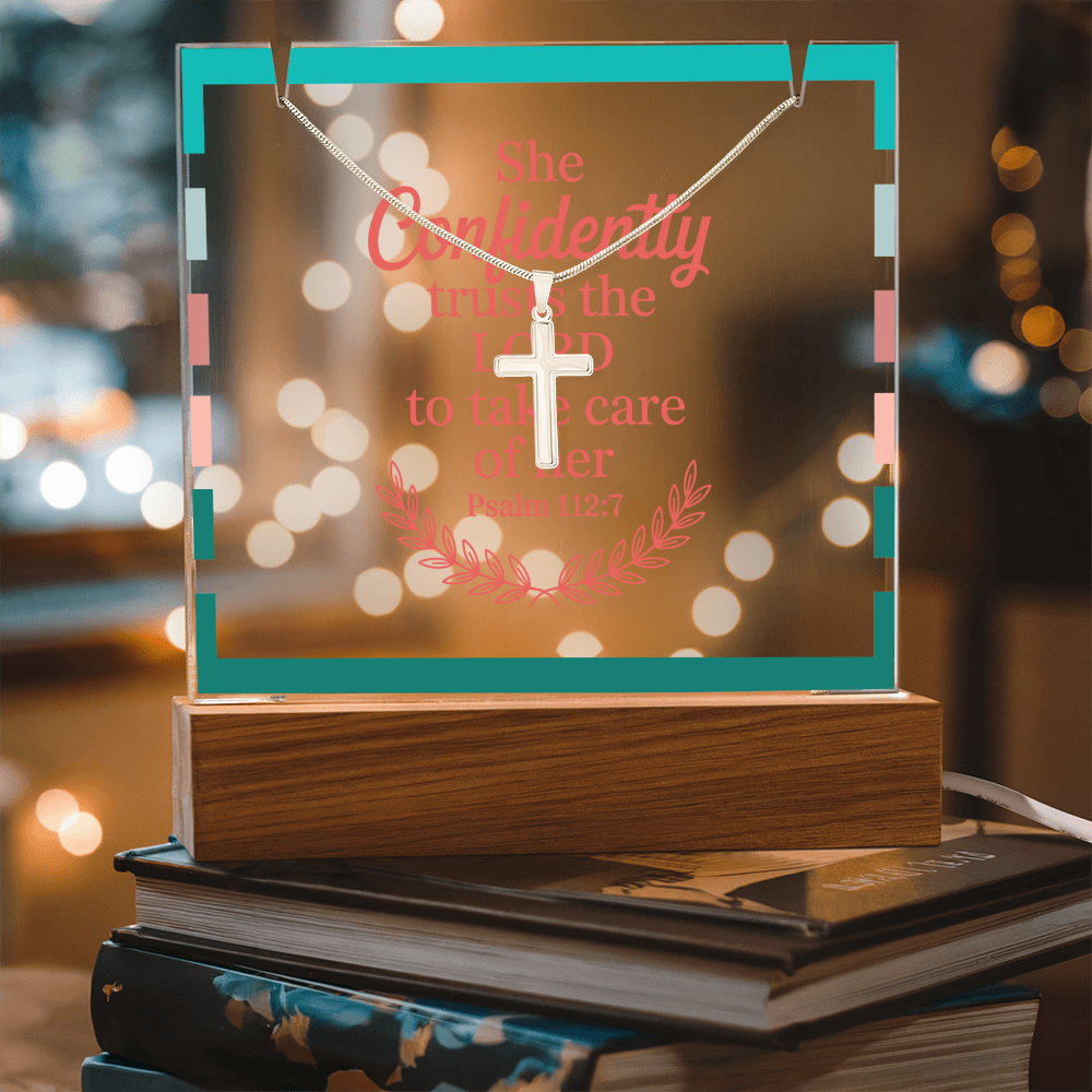 Close-up of printed Christian quote on clear acrylic illuminated by soft LED lighting.