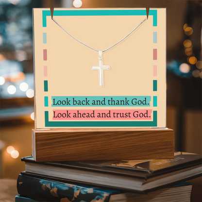 Close-up of stainless steel cross necklace with lobster clasp