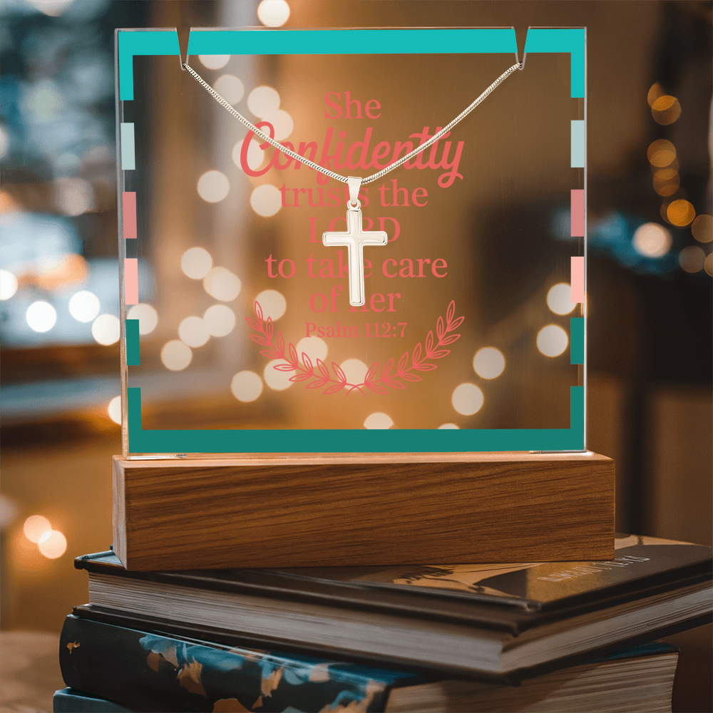 Christian gift set with cross necklace displayed next to floral arrangement and prayer book.