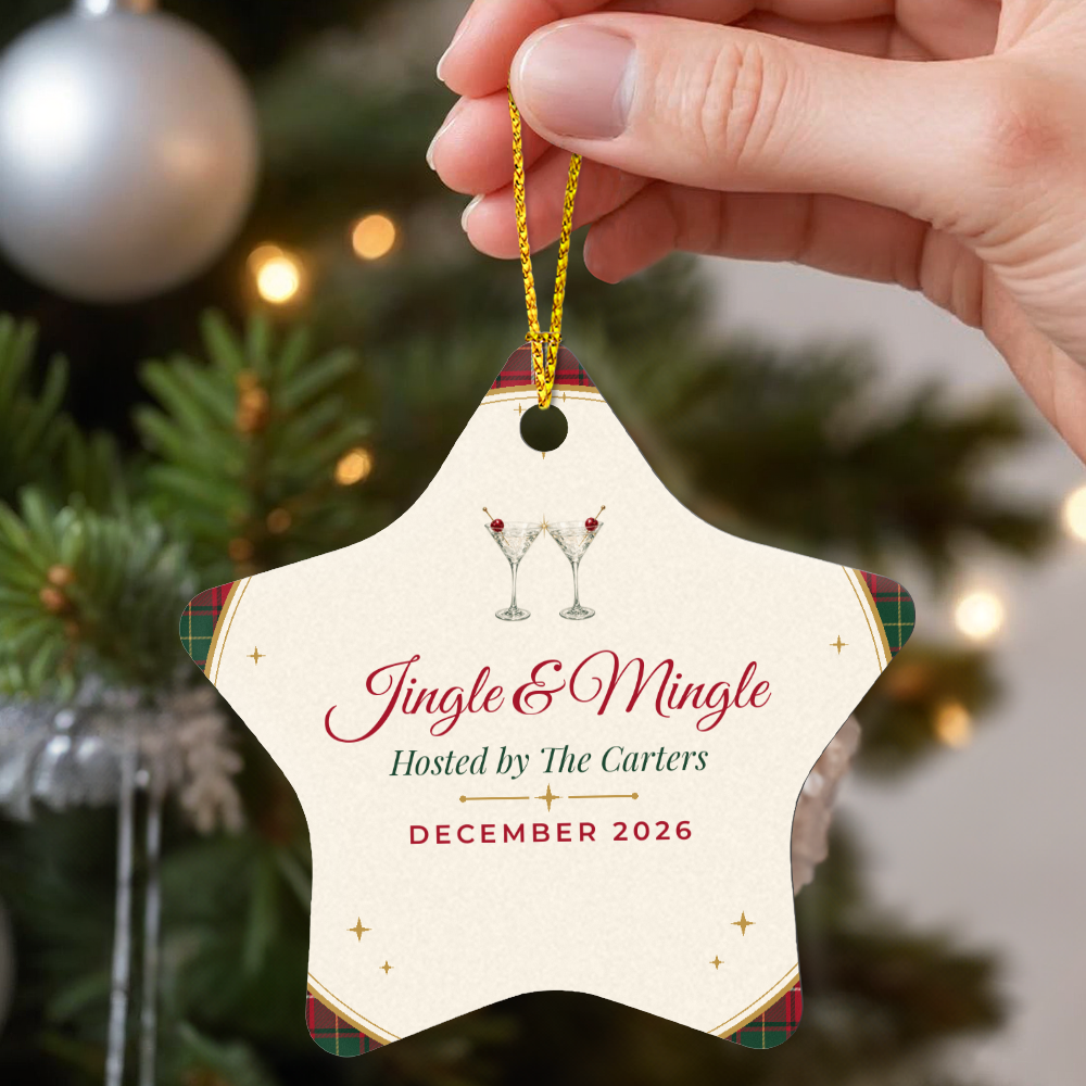 Hand holding the Jingle & Mingle star keepsake ornament by its gold cord beside a Christmas tree