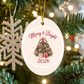 Merry & Bright 2026 ornament hanging on a Christmas tree beside a glitter snowflake