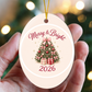 Merry & Bright 2026 pink Christmas tree ornament held in hand