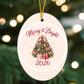 Merry & Bright 2026 high gloss keepsake ornament close-up against twinkling tree lights