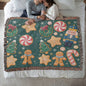 Woven holiday blanket with gingerbread and wreaths