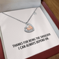 Sterling silver heart necklace with baby feet pendant
