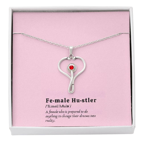 Female Hustler stethoscope necklace with heart-shaped pendant and red Swarovski crystal.