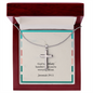Close-up of minimalist cross pendant reflecting soft light