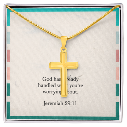 Cross pendant necklace styled beside Bible and journal