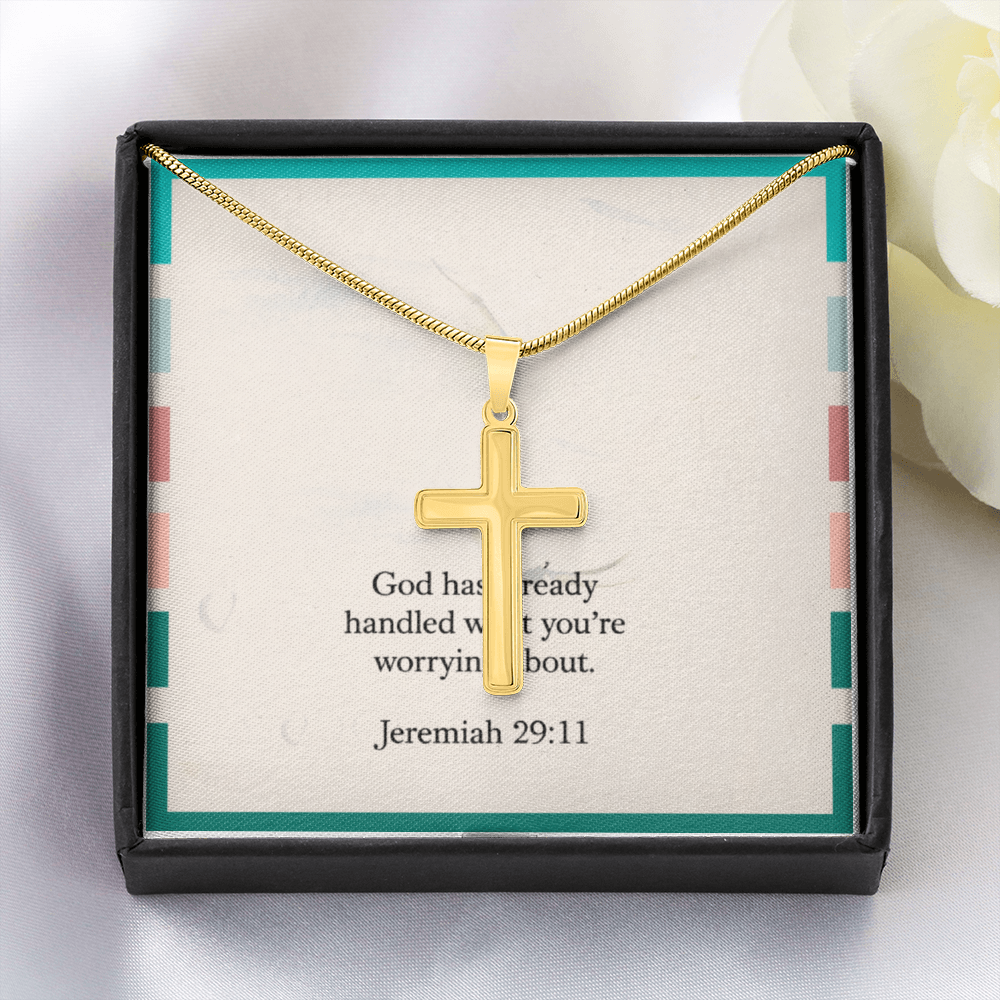 Polished stainless steel cross necklace glowing in natural light