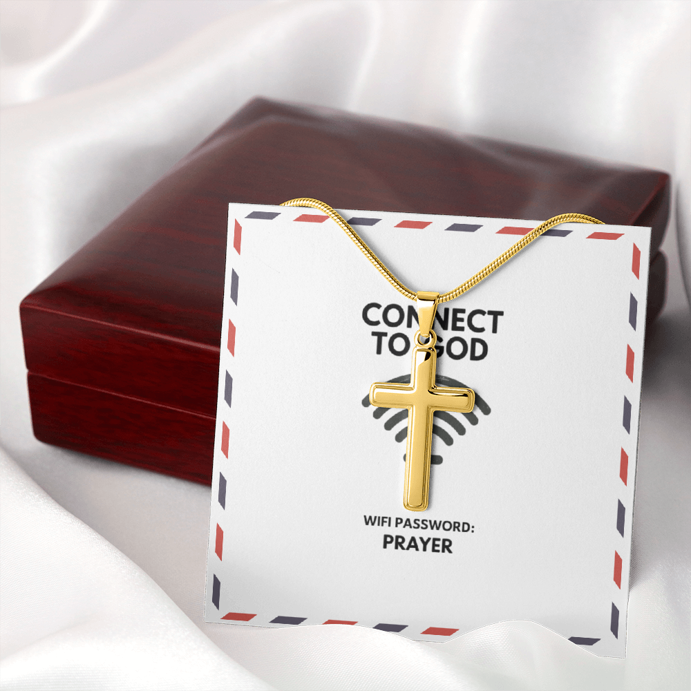 Stainless steel pendant beside open Bible and candle