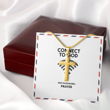 Stainless steel pendant beside open Bible and candle